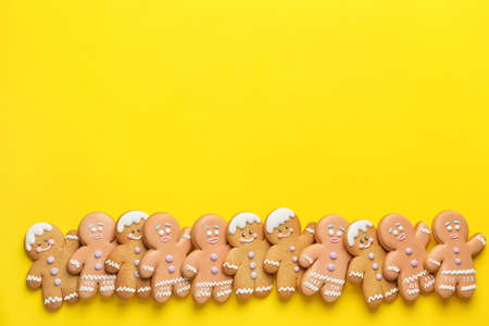 Tasty gingerbread cookies on color backgroundの写真素材