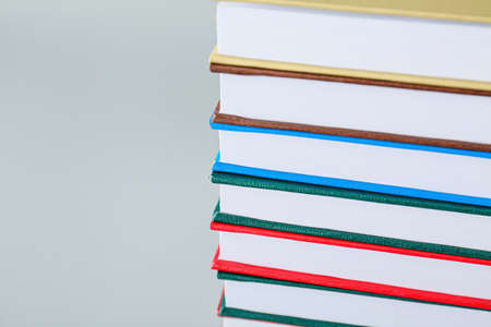 Stack of books on light background, closeup