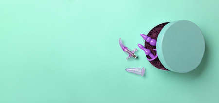 Box with different sex toys on color backgroundの写真素材