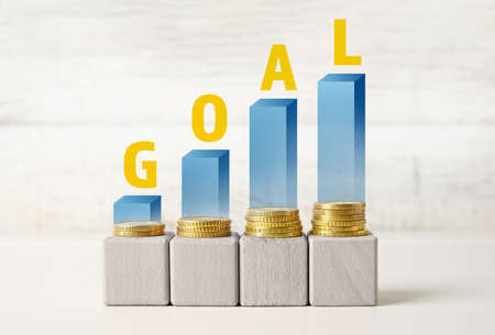 Cubes, coins and text GOAL on light backgroundの写真素材