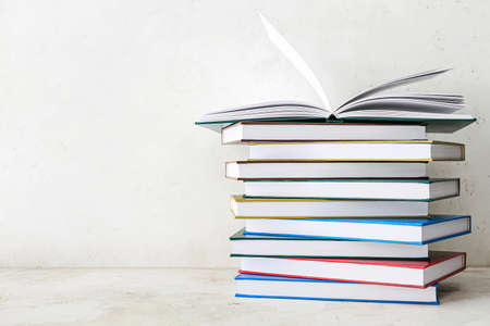 Stack of books on light background