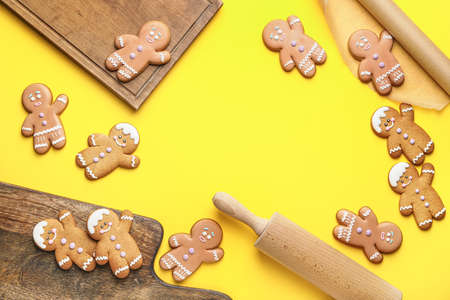 Composition with tasty gingerbread cookies on color background