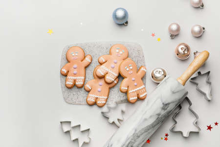 Tasty gingerbread cookies and Christmas decor on light backgroundの写真素材