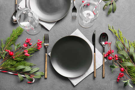 Beautiful Christmas table setting with mistletoe on dark background