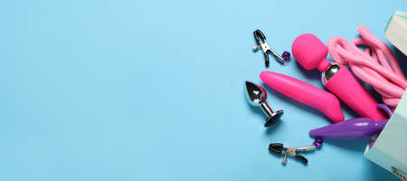 Many different sex toys on color background with space for text
