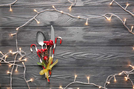 Beautiful Christmas table setting with mistletoe on wooden backgroundの写真素材
