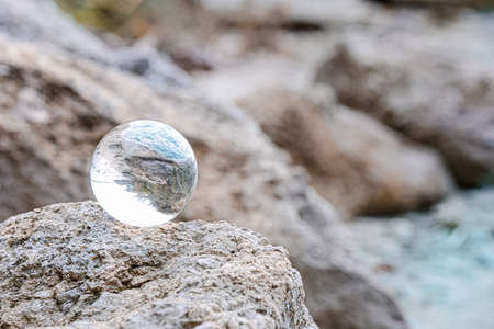 Crystal ball of fortune teller outdoors near riverの写真素材