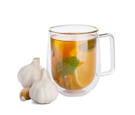 Cup of healthy garlic tea on white backgroundの写真素材