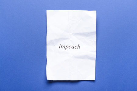 Crumpled paper with word IMPEACH on color background