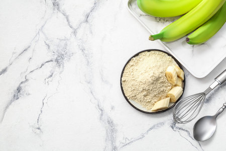 Plate with banana flour on light backgroundの写真素材