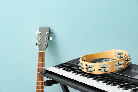 Different musical instruments on color background, closeup
