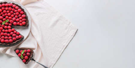 Tasty cut raspberry pie on light background with space for textの写真素材