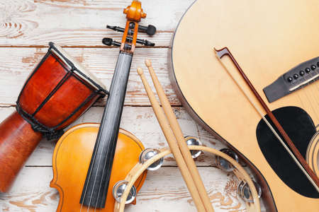 Different musical instruments on light wooden background, closeupの写真素材