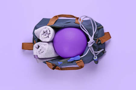 Bag with sports items on color backgroundの写真素材