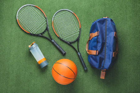 Composition with bag and sports equipment on color backgroundの写真素材