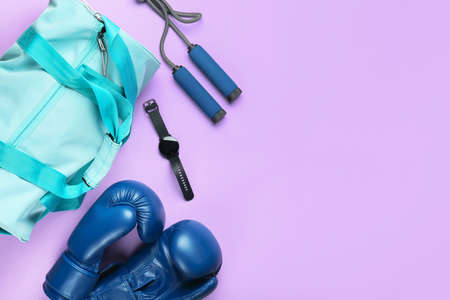 Composition with bag and sports equipment on color background