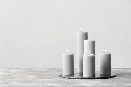 Beautiful aroma candles on gray backgroundの写真素材