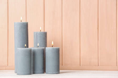 Beautiful aroma candles on table in roomの写真素材