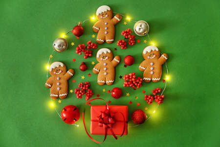 Christmas composition with gingerbread cookies on color background