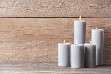 Beautiful aroma candles on wooden backgroundの写真素材