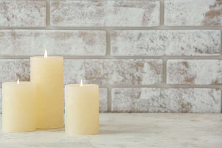 Beautiful aroma candles on table in roomの写真素材