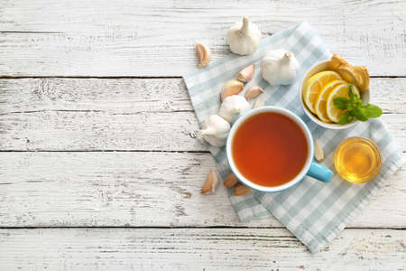 Cup of healthy garlic tea on tableの写真素材