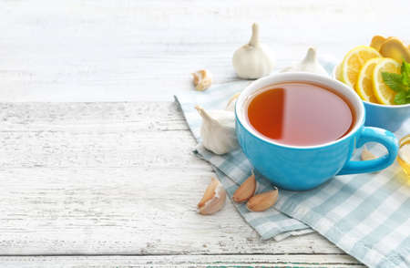 Cup of healthy garlic tea on tableの写真素材