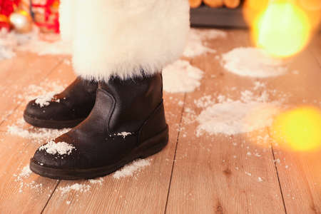 Feet of Santa and his snow footprints on floor in roomの写真素材