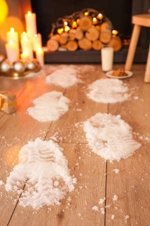 Footprints of Santa on floor in room decorated for Christmasの写真素材