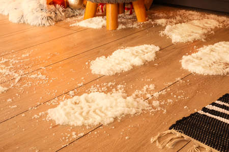 Footprints of Santa on floor in room decorated for Christmas