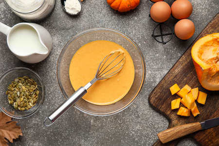 Preparing of tasty pumpkin muffins on tableの写真素材