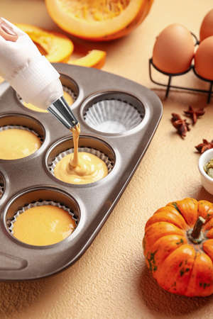 Preparing of tasty pumpkin muffins on tableの写真素材