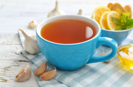Cup of healthy garlic tea on tableの写真素材