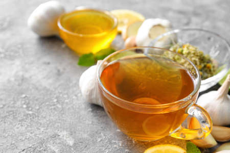 Cup of healthy garlic tea on grunge backgroundの写真素材