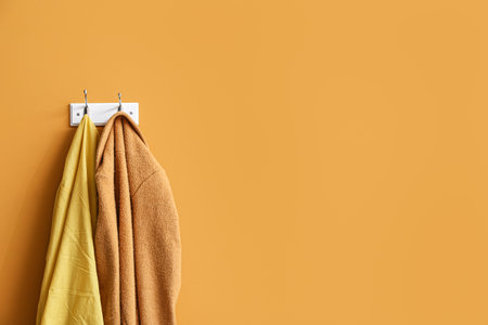 Hanger with clothes on color backgroundの写真素材