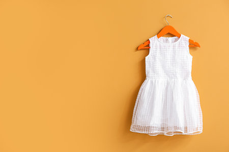 Hanger with dress on color backgroundの写真素材