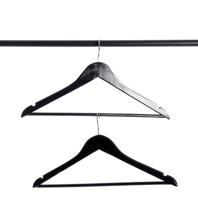Clothes hangers on rack against white backgroundの写真素材
