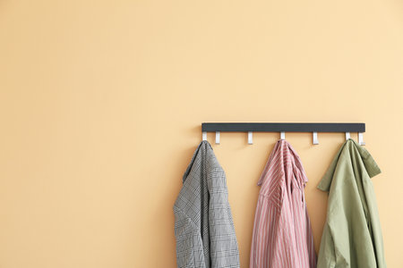 Hanger with clothes on color backgroundの写真素材