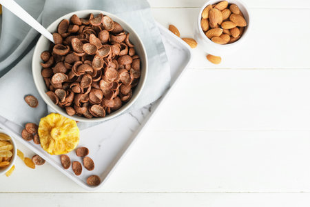 Composition with tasty cornflakes on light wooden backgroundの写真素材