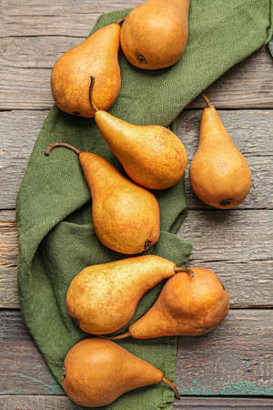 Fresh ripe pears on wooden background