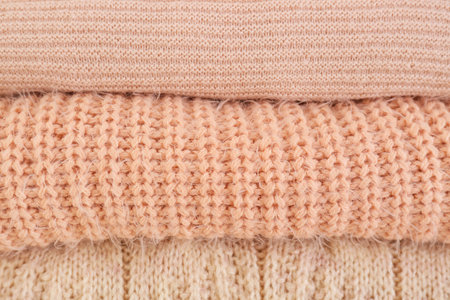 Stack of warm winter clothes as background
