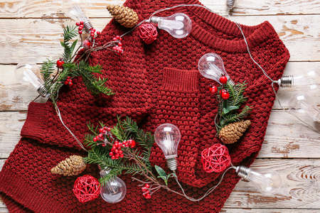 Warm winter clothes with Christmas decorations on tableの写真素材