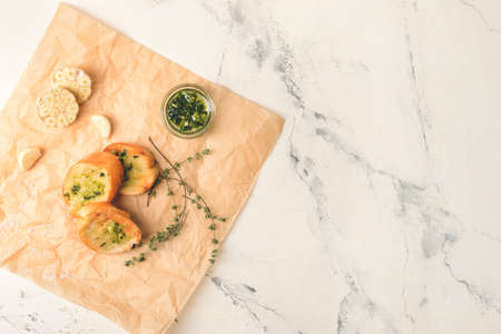 Slices of toasted bread with garlic on light backgroundの写真素材
