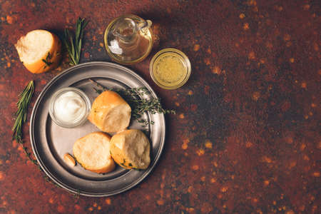 Plate with fresh bread and different spices on grunge backgroundの写真素材