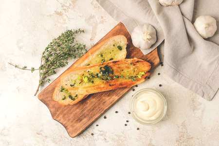 Composition with toasted bread and different spices on light backgroundの写真素材