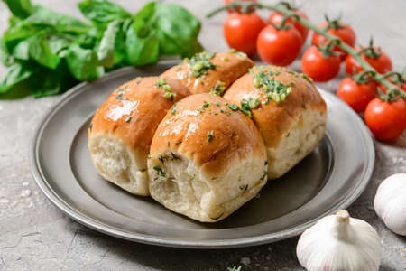 Composition with fresh bread and garlic on gray background