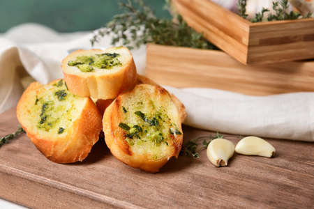 Toasted bread and garlic on color background, closeupの写真素材