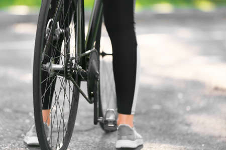 Female cyclist riding bicycle outdoorsの写真素材