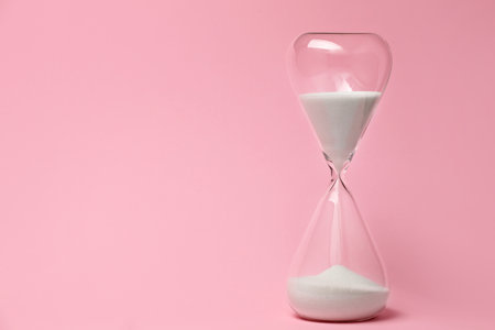 Hourglass on color background. Time management concept