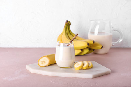 Glass of tasty banana smoothie on tableの写真素材